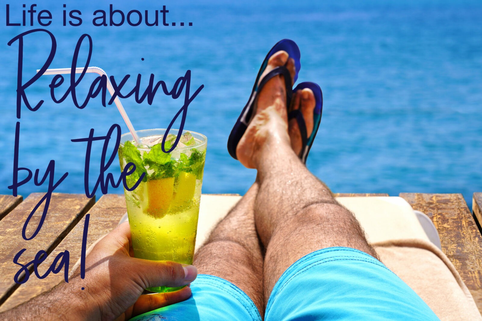 Man relaxing on sunbed and sunbathing with a cold mojito drink on the wooden beach pier.